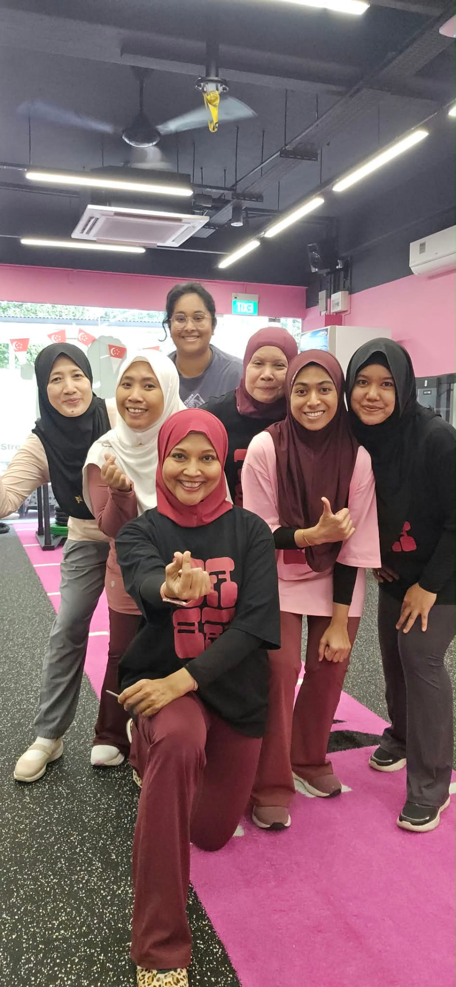 Haslinda Ali with smiling FitFab.sg members after a training session